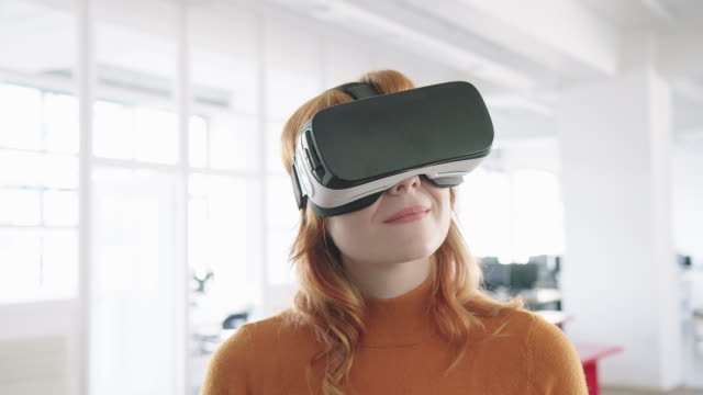 Businesswoman using VR glasses in office
