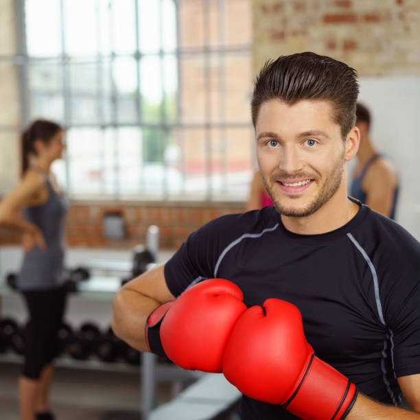 istock Handsome man holding boxing gloves together 1146454834