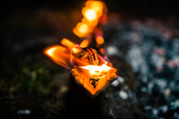flash of a flame close up on dark coil background