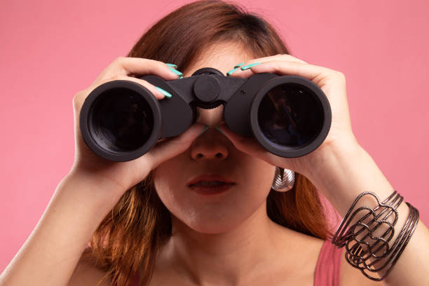 istock Young Asian woman with binoculars. 1146458643