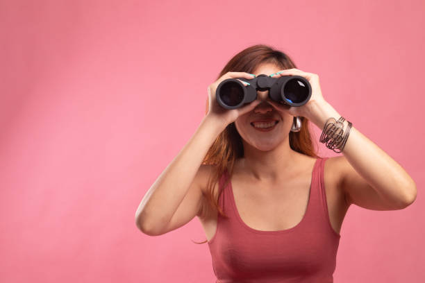 istock Young Asian woman with binoculars. 1146461772