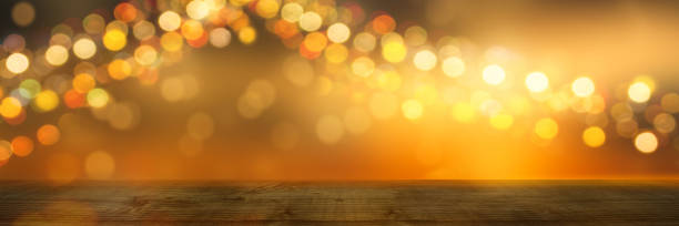 istock festive background with wooden table and shiny lights 1146464207
