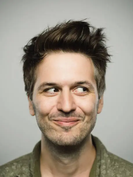 Photo of Portrait of real caucasian man with happy expression looking to the side