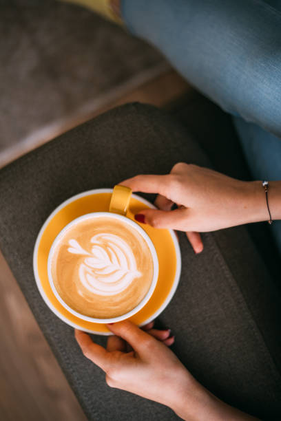 istock Lady's hands holding cup with latte art 1146465117