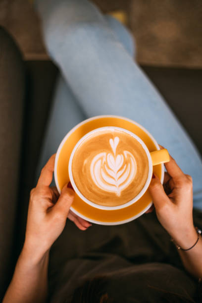 istock Lady's hands holding cup with latte art 1146465278