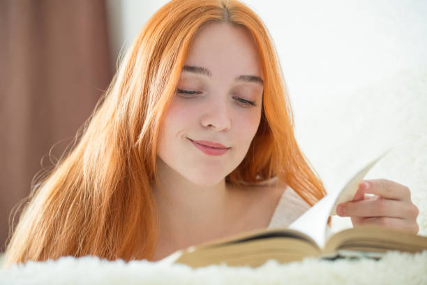 istock a young woman is reading a book 1146465434