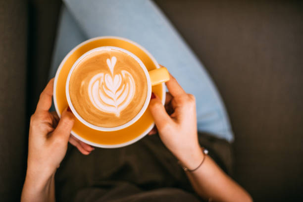 istock Lady's hands holding cup with latte art 1146465478