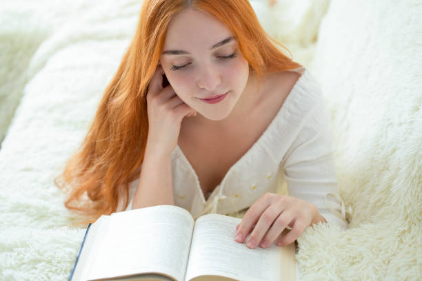 istock a young woman is reading a book 1146465480