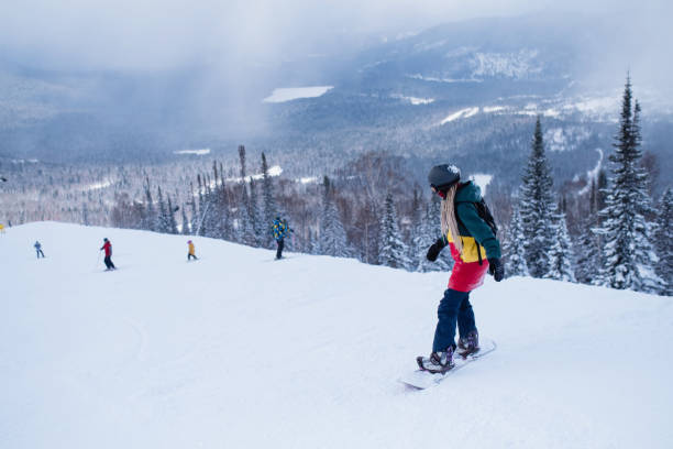 istock Female snowboarder slides down a snowy slope. 1146465497