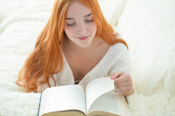 istock a young woman is reading a book 1146465579