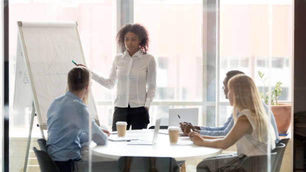istock African business coach consulting team working with whiteboard at training 1146468272
