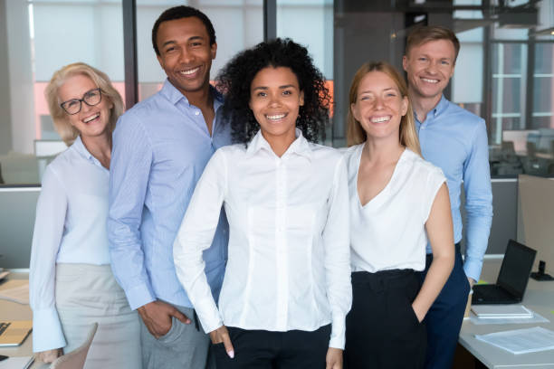 istock Smiling young african leader looking at camera with diverse team 1146468399