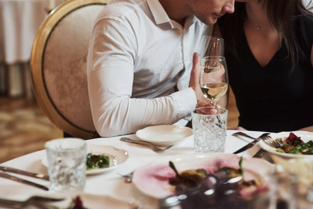 istock Talks about some things quietly. Beautiful couple have romantic dinner in luxury restaurant at evening time 1146469449