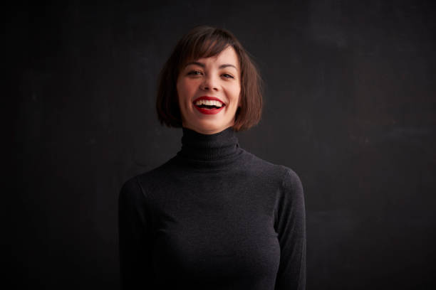 istock Beautiful young woman studio shot while standing at dark background 1146469762