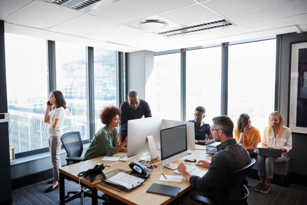 istock Creative business team working together in a busy casual office 1146471086