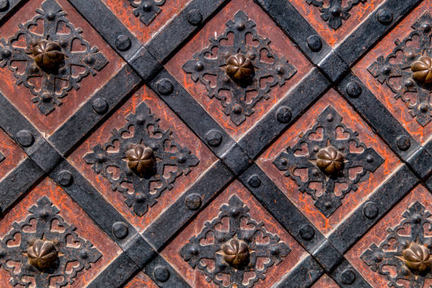 istock Ancient  gate with metal mounting and ironworks.  Beautiful decorative metal elements forged wrought iron gates. 1146471407
