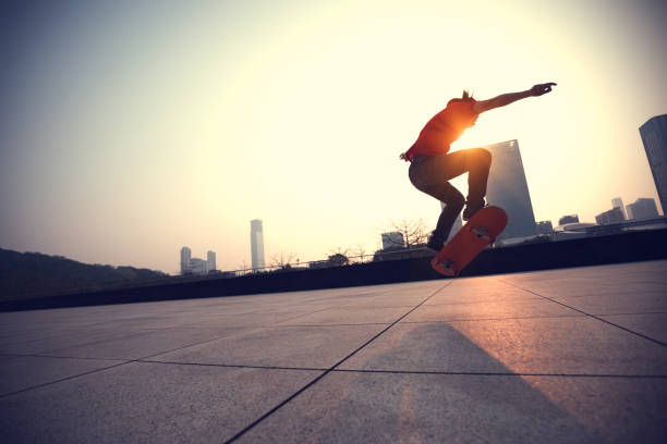istock Skateboarder skateboarding at sunrise city 1146472751