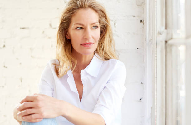 istock Attractive mature woman portrait while relaxing at the window 1146472784