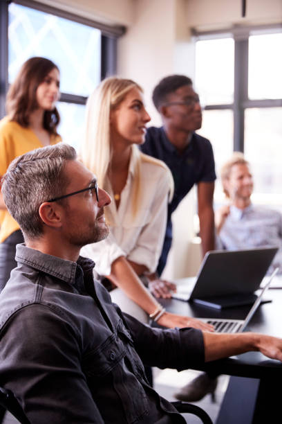 Creative business team listening at a brainstorm meeting, close up, vertical Creative business team listening at a brainstorm meeting, close up, vertical smart casual stock pictures, royalty-free photos & images