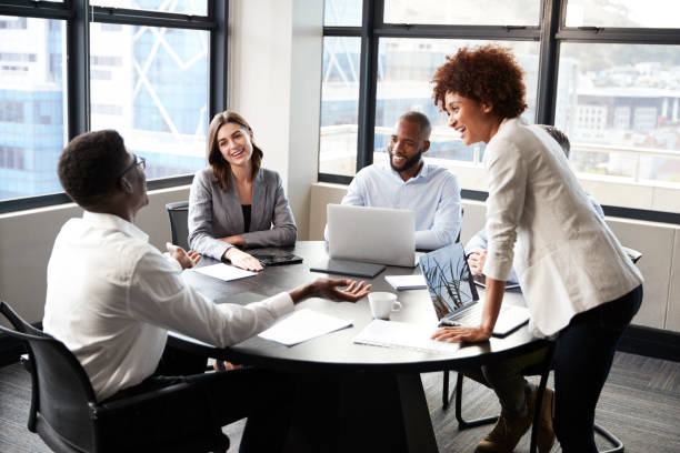 millennial black businesswoman stands listening to corporate colleagues at a meeting, close up - close up businessman corporate business side view imagens e fotografias de stock