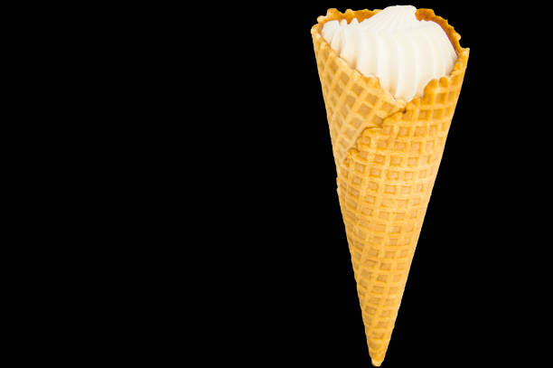 istock Vanilla ice cream in a waffle cone and black copy space with a saved clipping path, isolated 1146474411