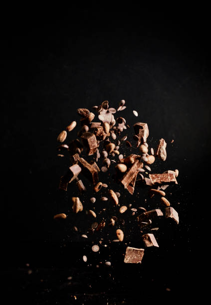 istock Chocolate Food Explosion with Cocoa Powder, Chocolate Chips and Nuts 1146474449