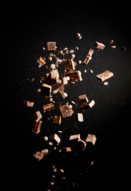 istock Chocolate Food Explosion with Cocoa Powder, Chocolate Chips and Nuts 1146474455