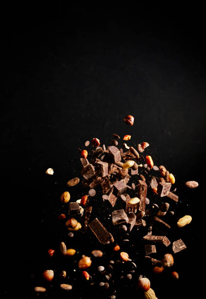 istock Chocolate Food Explosion with Cocoa Powder, Chocolate Chips and Nuts 1146474457