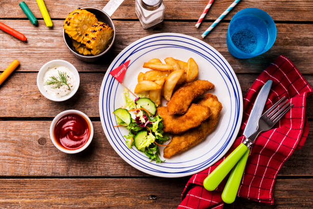 istock Kid's meal - chicken strips, fries, salad, corn and dips 1146475917