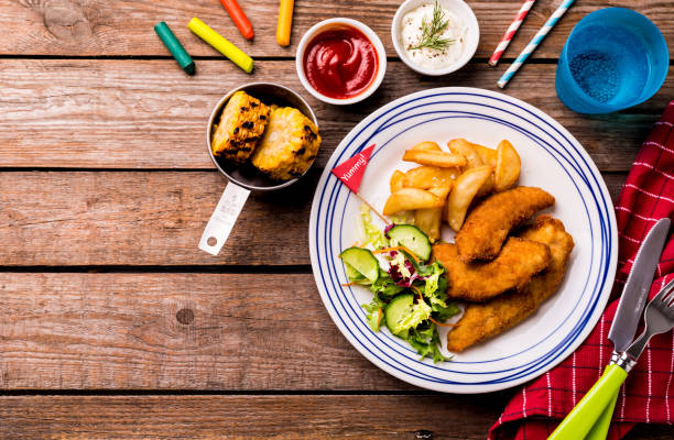 kid's meal - chicken strips, fries, salad, corn and dips - food dining cooking multi colored imagens e fotografias de stock