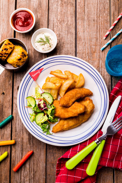 istock Kid's meal - chicken strips, fries, salad, corn and dips 1146475926
