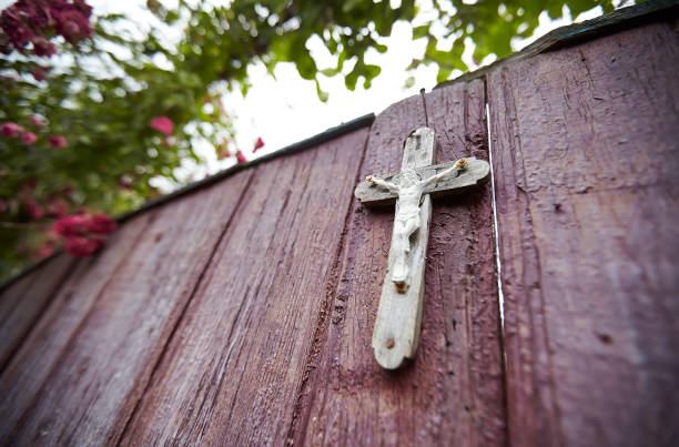 istock Rose bush on wooden gate with a cross 1146476375