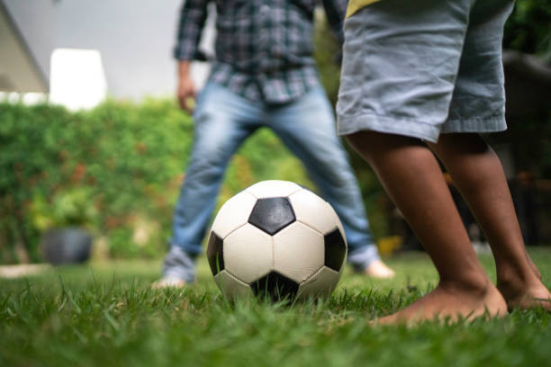 istock Father and son playing soccer in backyard 1146477284