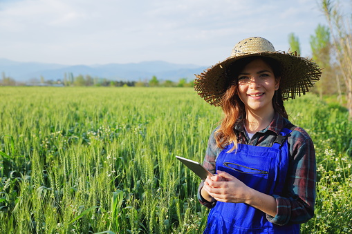 Young female farmer with digital tablet