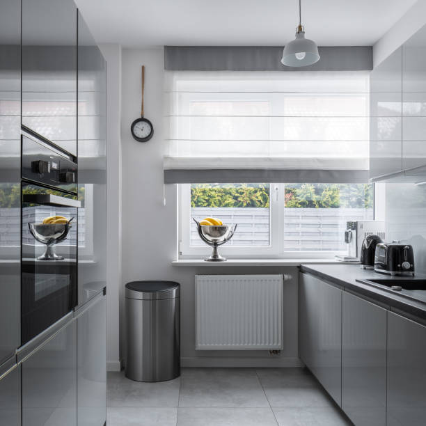 istock Narrow kitchen with gray furniture 1146479774