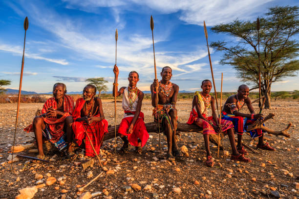 African warriors from Samburu tribe, central Kenya, East Africa African warriors from Samburu tribe resting on savanna, central Kenya. Samburu tribe is one of the biggest tribes of north-central Kenya, and they are related to the Maasai. masai stock pictures, royalty-free photos & images