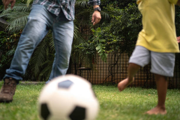 istock Father and son playing soccer in backyard 1146481246