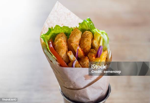 Greek Gyros With Fried Shrimp Tzatziki Sauce Vegetables Feta Cheese And French Fries Stock Photo - Download Image Now