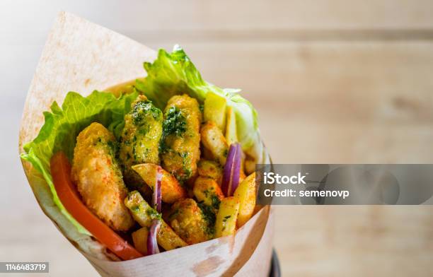 Greek Gyros With Fried Shrimp Tzatziki Sauce Vegetables Feta Cheese And French Fries Stock Photo - Download Image Now