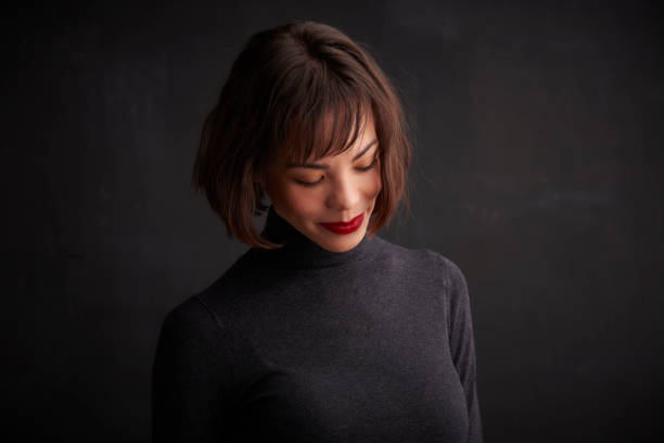 istock Beautiful young woman smiling and looking down 1146484068