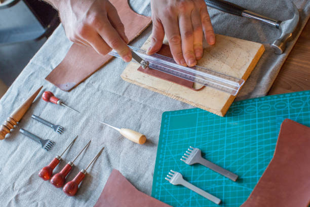 istock Craft man is working on his leather craft, making vintage leather bag by leather work tool. 1146484995