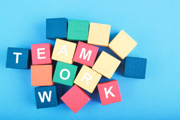 istock TEAMWORK word on wooden cube over blue background for cooperation, togetherness or partnership concept 1146486082