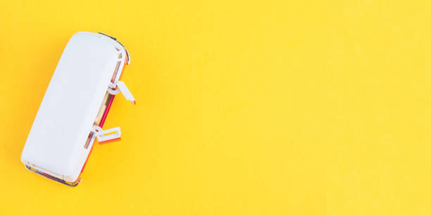 istock Miniature toy van on yellow background for travelling concept. copy space for text 1146486341