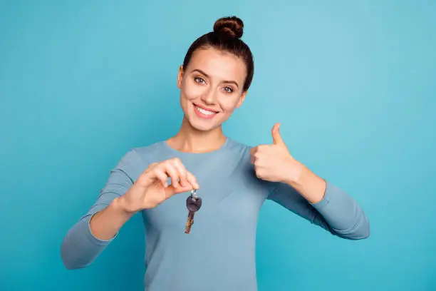 Portarit positive cheerful real estate agent top-knot offer advert excellent choose advice decide perfect promo satisfied content hipster trendy stylish sweater isolated beautiful blue background.