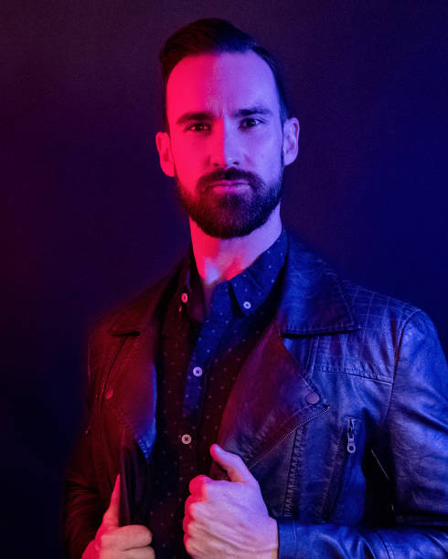 istock Handsome man wearing a leather jacket with blue and red gel lighting 1146488145