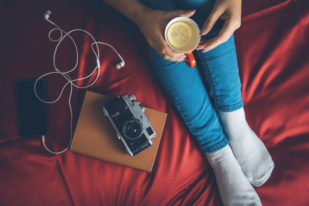 istock woman in bed hand tea 1146488381