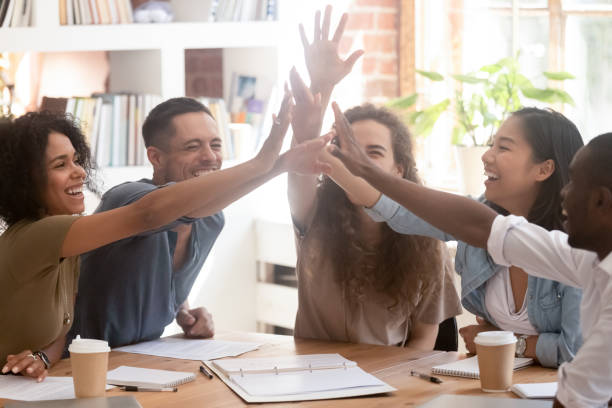 istock Cheerful workers or schoolmates feels happy giving high five 1146488530