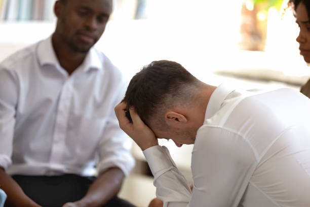 istock Diverse people during group therapy focus on desperate caucasian guy 1146488555