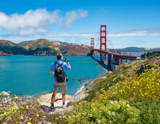 istock Man standing on top of the mountain using his camera on vacation trip. 1146488578