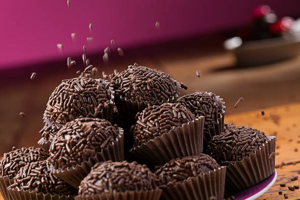 Sweet chocolate Brigadeiro on wooden background stock photo